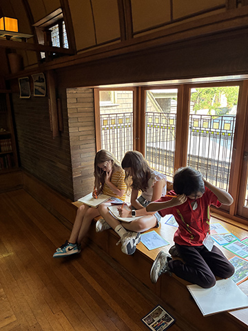 Campers gather in the playroom of the Home & Studio and design animal habitats.